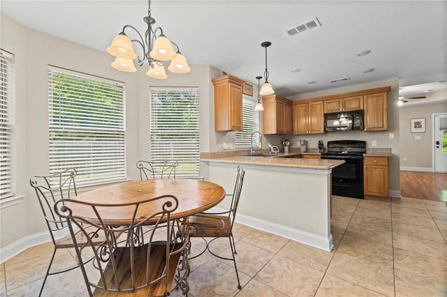 kitchen featuring an inviting chandelier, light stone counters, decorative light fixtures, black appliances, and light tile patterned flooring