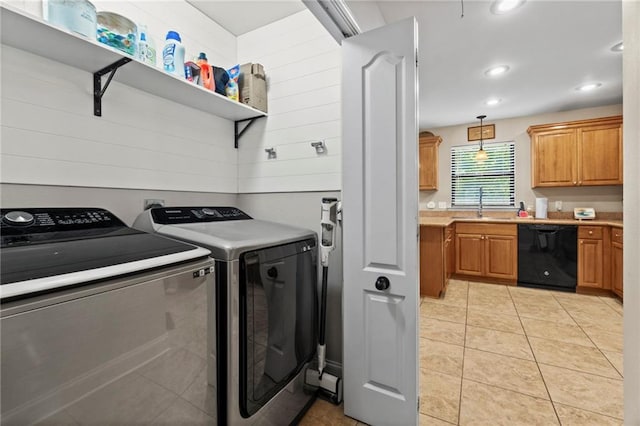 washroom featuring sink, washer and clothes dryer, and light tile patterned floors