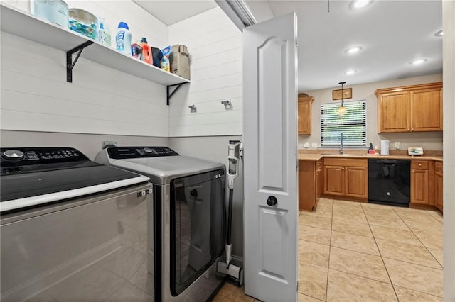 clothes washing area with independent washer and dryer, a sink, recessed lighting, light tile patterned floors, and laundry area