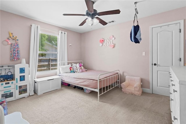 carpeted bedroom with visible vents and ceiling fan