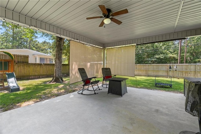 view of patio with a fenced backyard and ceiling fan