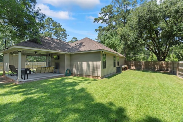 back of property with a patio area, ceiling fan, an outdoor living space, and a lawn