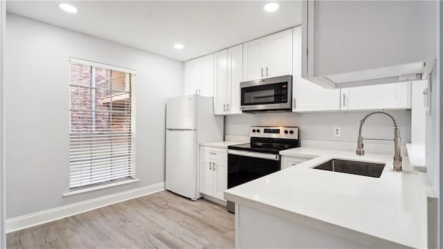 kitchen featuring white cabinets, light hardwood / wood-style flooring, sink, and stainless steel appliances