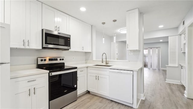 kitchen with sink, stainless steel appliances, light hardwood / wood-style flooring, and white cabinets