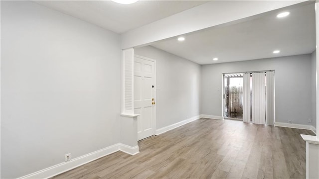 spare room with light wood-style flooring, baseboards, and recessed lighting