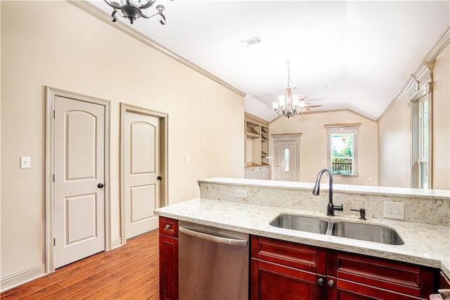 kitchen with sink, light hardwood / wood-style flooring, a chandelier, vaulted ceiling, and dishwasher