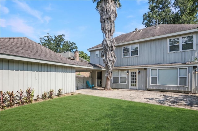 rear view of house with a lawn