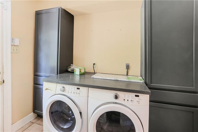 washroom featuring washing machine and clothes dryer and light tile patterned flooring