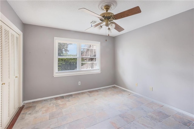 unfurnished bedroom with a closet, ceiling fan, and tile patterned floors