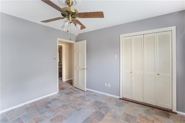 unfurnished bedroom with ceiling fan, tile patterned flooring, and a closet