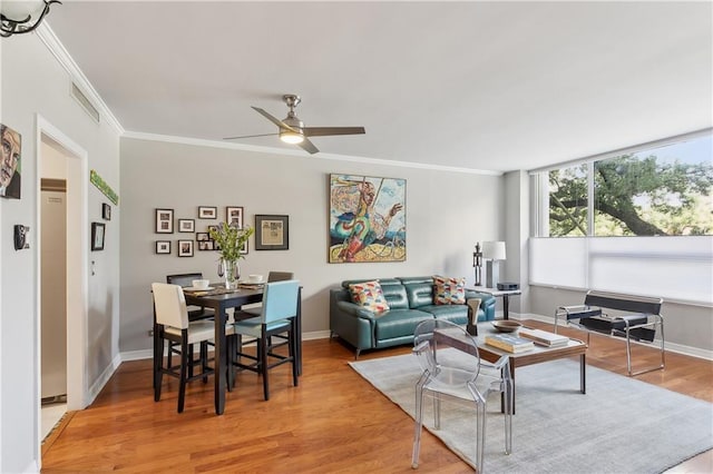 living room featuring ceiling fan, hardwood / wood-style floors, and ornamental molding