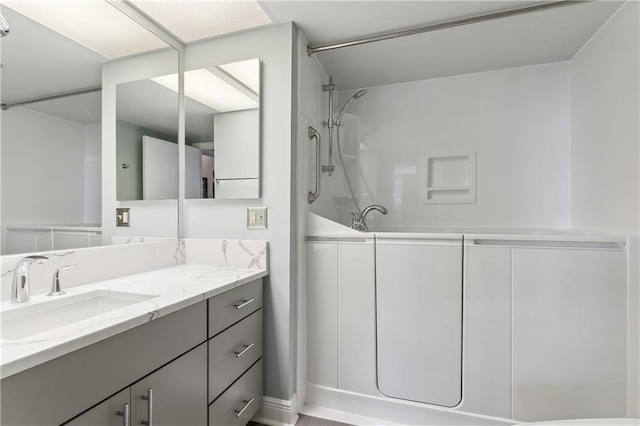 bathroom with a shower and vanity