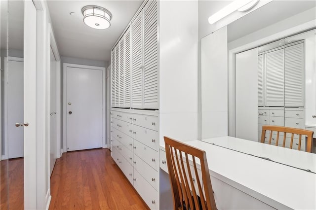 corridor with hardwood / wood-style flooring