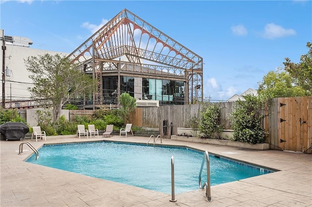 view of swimming pool featuring a patio area