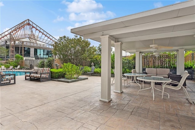 view of patio / terrace featuring a gazebo, outdoor lounge area, ceiling fan, and a fenced in pool