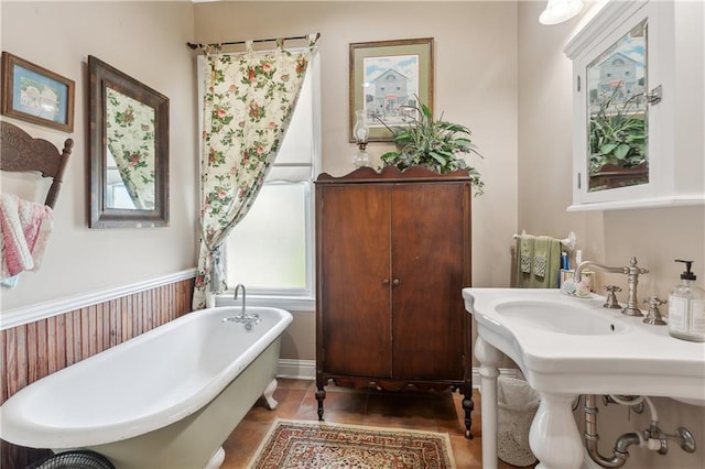 bathroom with tile patterned floors and a tub