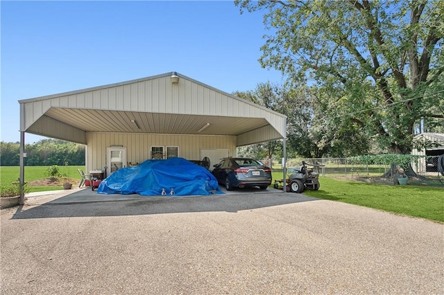 view of parking / parking lot with a lawn