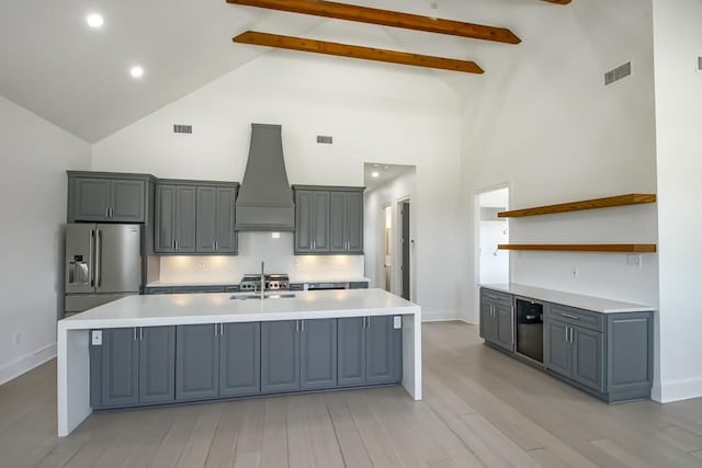 kitchen featuring custom range hood, high vaulted ceiling, high end refrigerator, and beamed ceiling