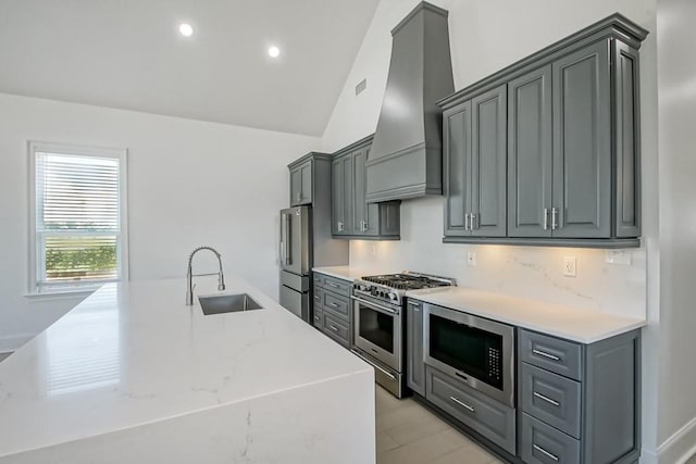 kitchen with appliances with stainless steel finishes, sink, custom range hood, and gray cabinetry