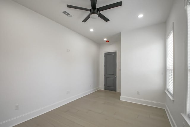 spare room with ceiling fan and wood-type flooring