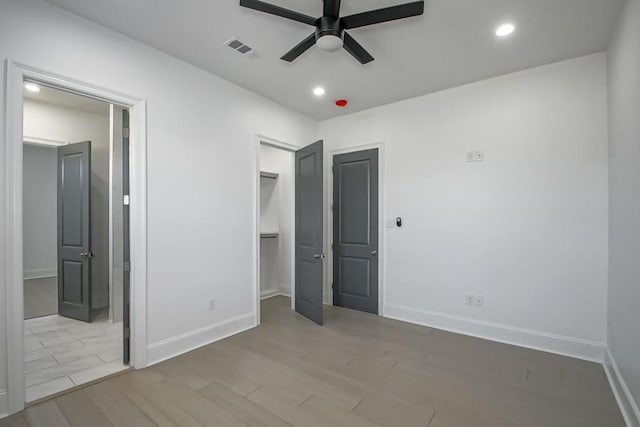 unfurnished bedroom featuring ceiling fan and light wood-type flooring