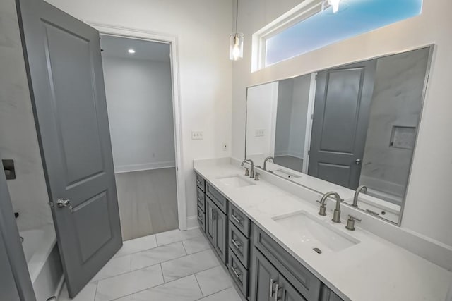 bathroom featuring hardwood / wood-style flooring and double vanity