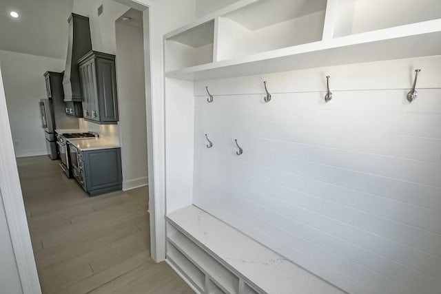 mudroom with light hardwood / wood-style floors