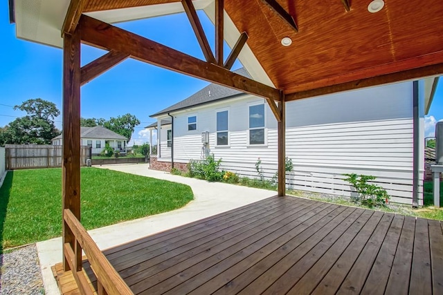 wooden terrace with a patio and a yard