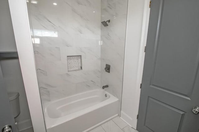 bathroom featuring tiled shower / bath combo and tile patterned floors