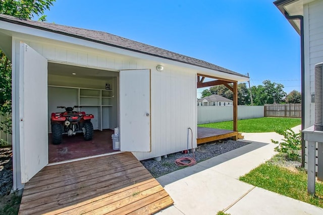 exterior space featuring a wooden deck and an outbuilding