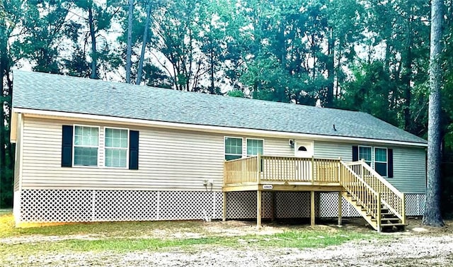 rear view of property featuring a deck