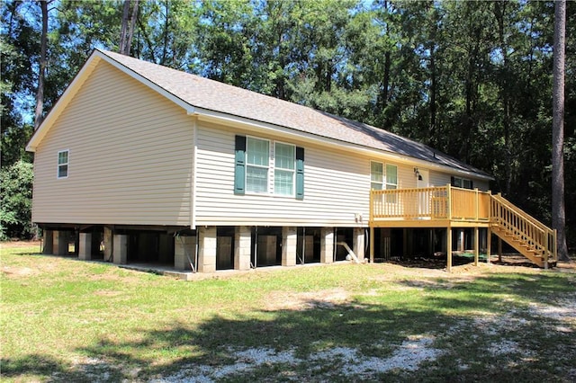 rear view of house with a yard and a deck