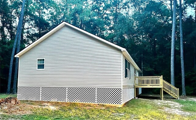 view of side of home featuring a wooden deck