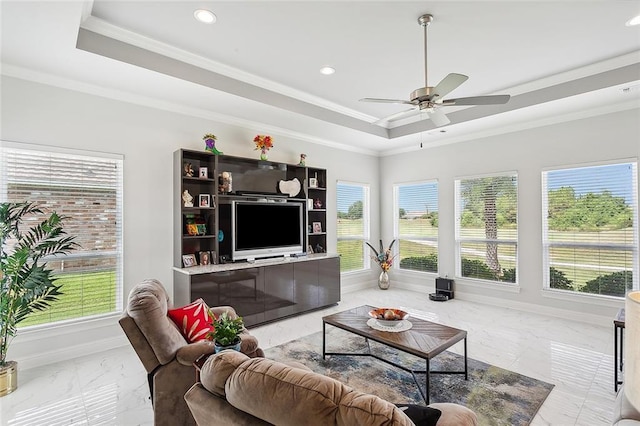 living room with a wealth of natural light, ceiling fan, and ornamental molding