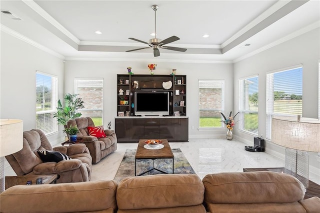 living room with plenty of natural light, ceiling fan, and ornamental molding