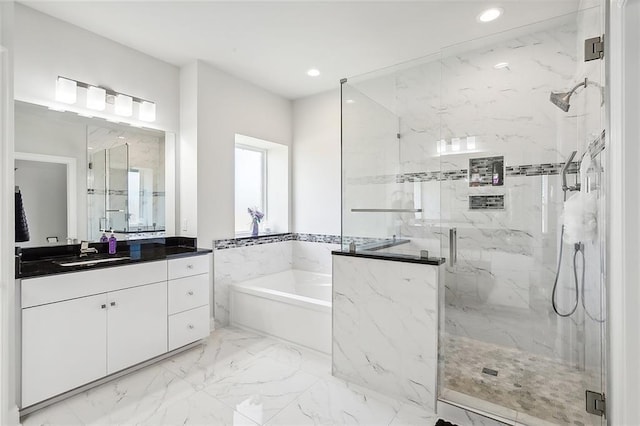 bathroom with vanity and independent shower and bath