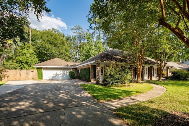 ranch-style home with a garage and a front yard