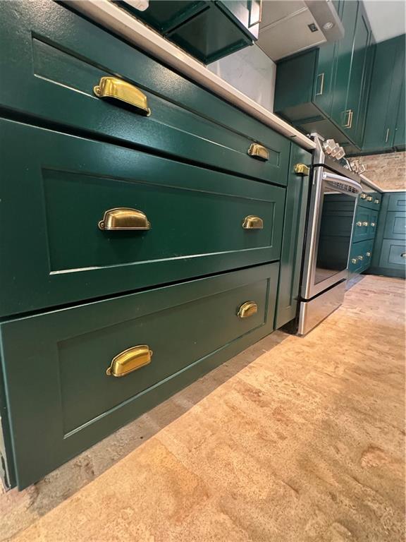 room details featuring stainless steel oven, green cabinets, and light colored carpet