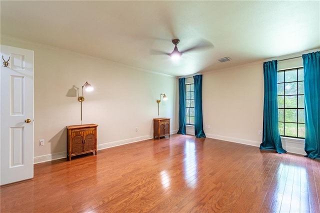 spare room with ornamental molding, hardwood / wood-style floors, and ceiling fan