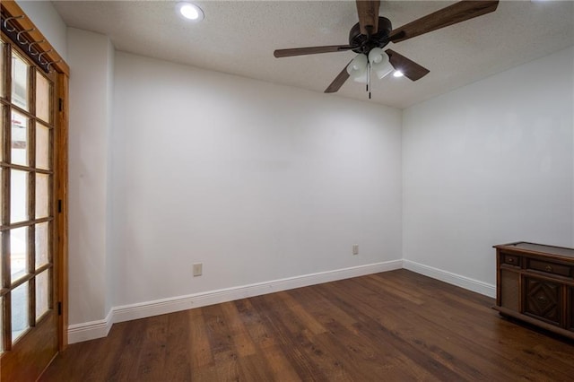 unfurnished room with ceiling fan, dark hardwood / wood-style floors, and a textured ceiling