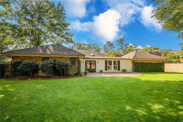 back of house with a patio and a yard