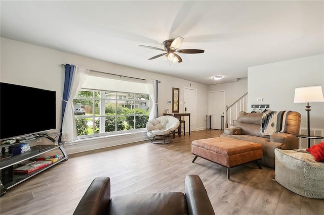 living room with ceiling fan and light wood-type flooring