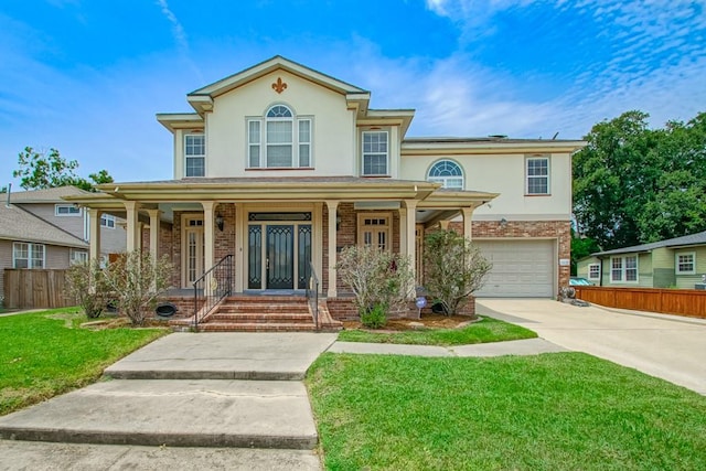 view of front of home with a garage, a front yard, and covered porch