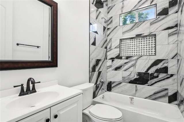 full bathroom featuring toilet, tiled shower / bath, and vanity