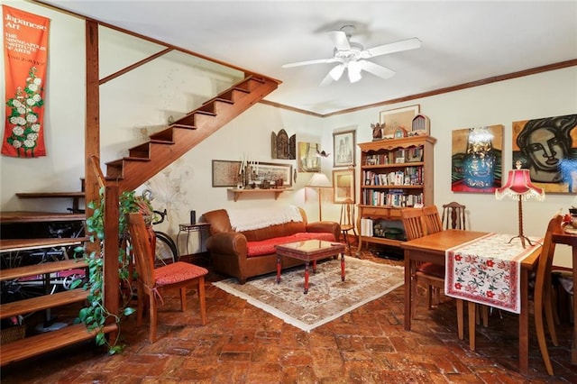 interior space with ceiling fan and crown molding