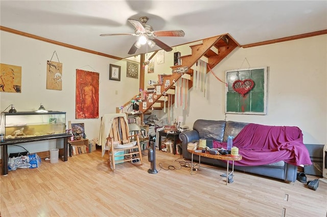 living area featuring light hardwood / wood-style flooring, ceiling fan, and ornamental molding