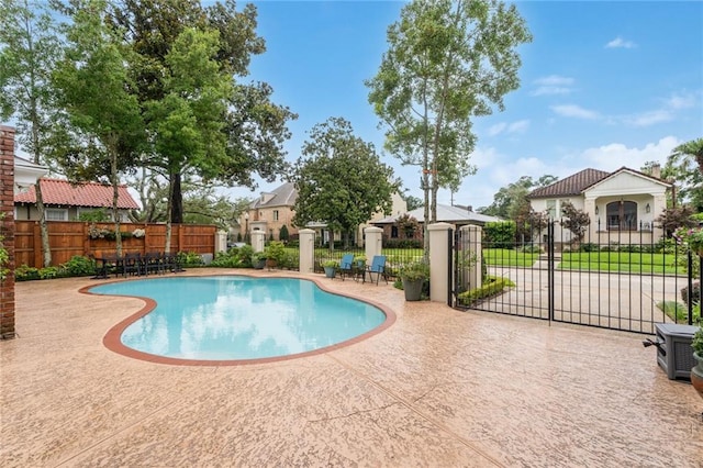 view of swimming pool featuring a patio area, fence, and a fenced in pool