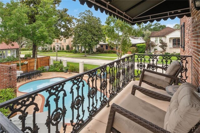 balcony featuring a fenced in pool