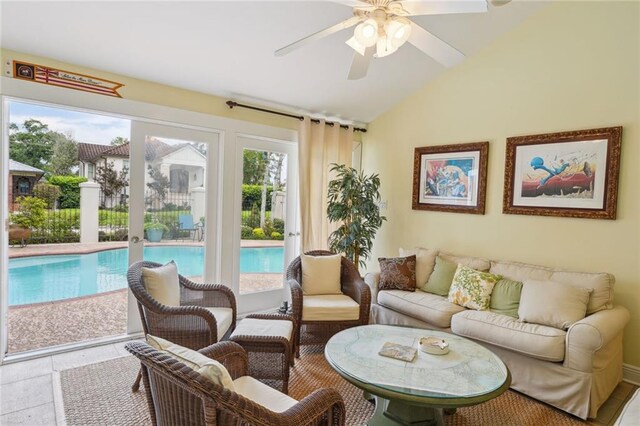 tiled living room with ceiling fan and vaulted ceiling