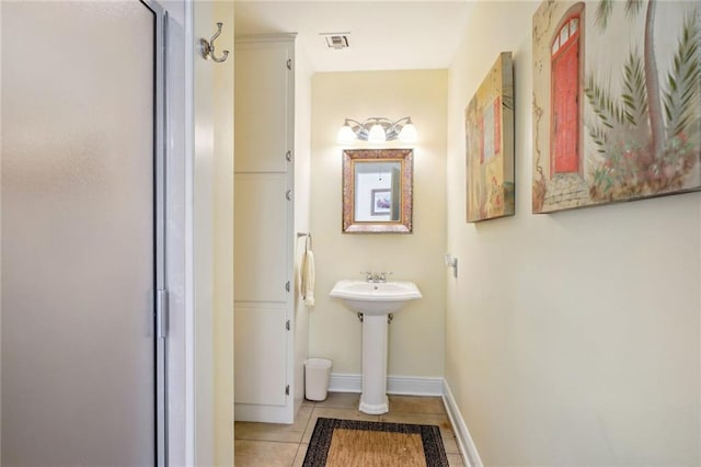 bathroom with sink and tile patterned flooring